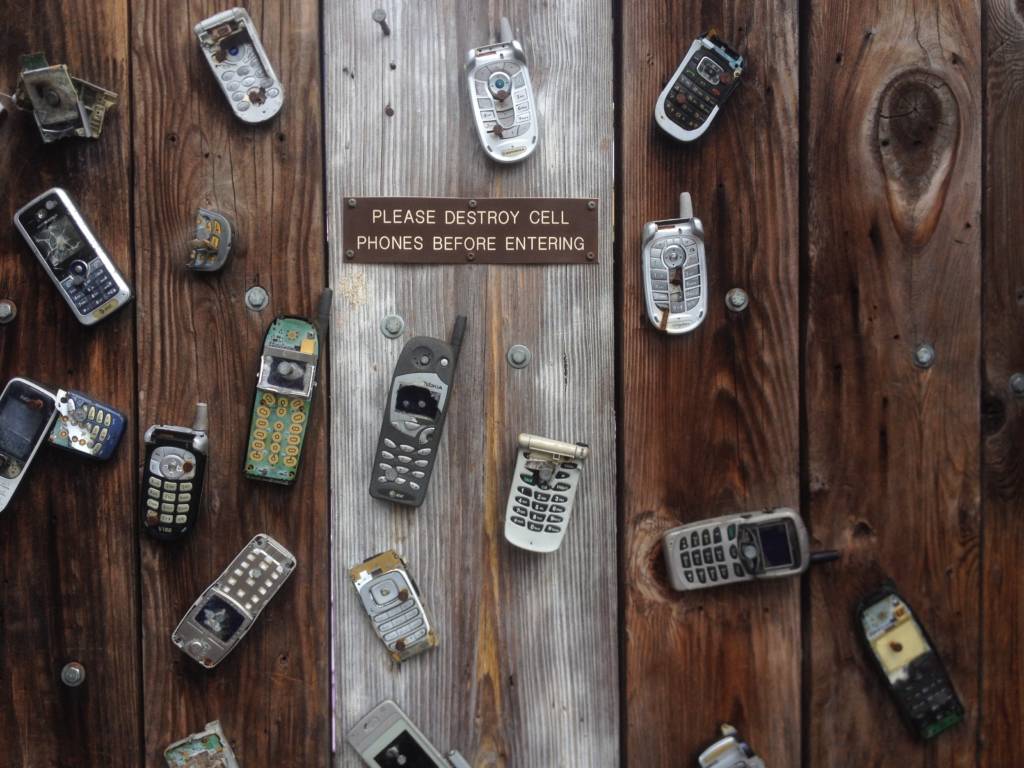 smartphones nailed to wall